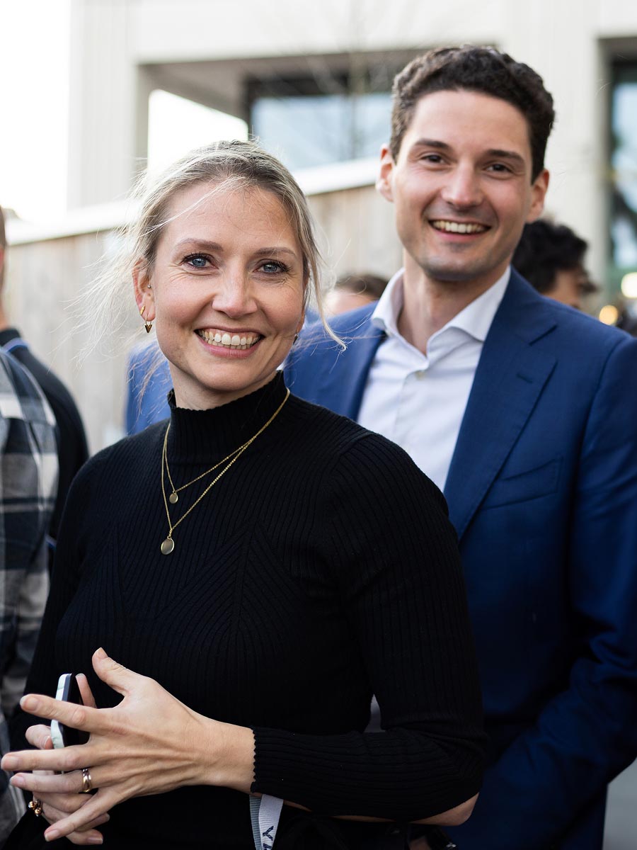 Corporate event guests photographed in motion under ambient venue lighting 16