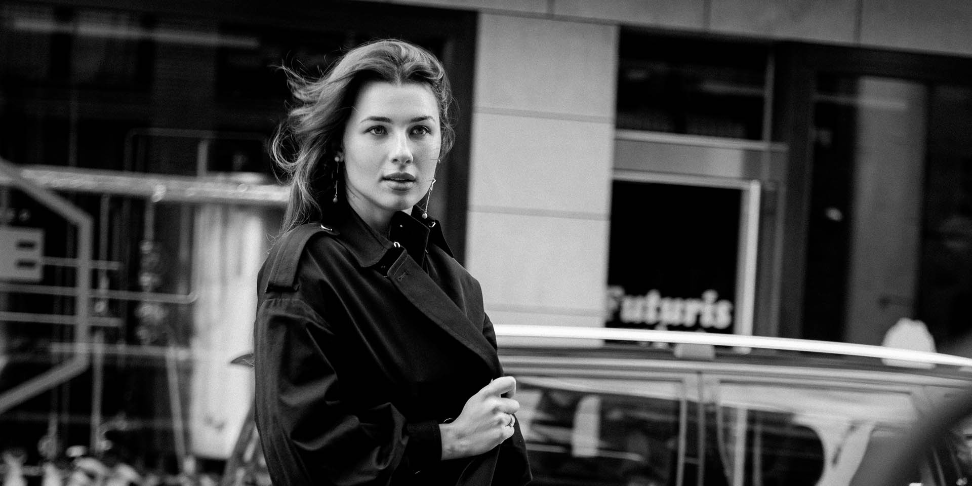 Fashion portrait of a woman reading a newspaper on a Maastricht street 2